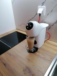 a coffee maker sitting on a counter with a cup of coffee at Crystal Blue Apartments in Nea Kalikratia