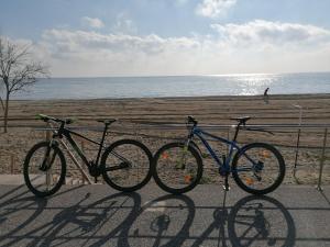 two bikes are parked next to the beach at Crystal Blue Apartments in Nea Kalikratia
