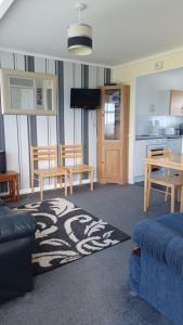 a living room with a couch and a table and a kitchen at alicias chalets ,free WIFI & swimming pool passes in Great Yarmouth
