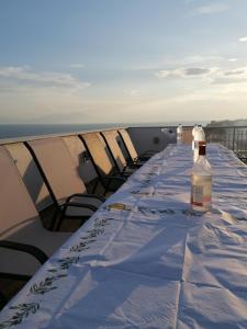 a long table with two bottles of wine sitting on top at Crystal Blue Apartments in Nea Kalikratia