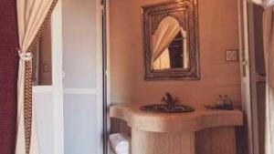 a bathroom with a sink and a mirror at Erg Chebbi Luxury Camp in Merzouga