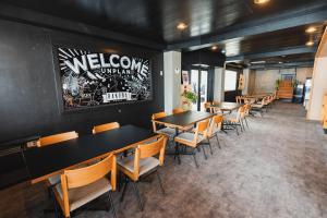 a row of tables and chairs in a restaurant at UNPLAN Village Hakuba in Otari