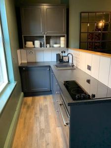 a kitchen with a sink and a stove top oven at The Nook, Morpeth Town in Morpeth