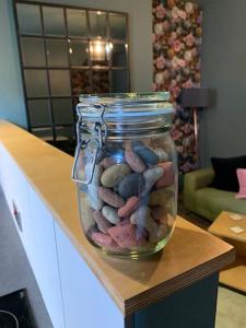 a glass jar filled with rocks on a table at The Nook, Morpeth Town in Morpeth