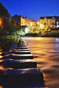 a row of stepping stones on a river at night at The Nook, Morpeth Town in Morpeth