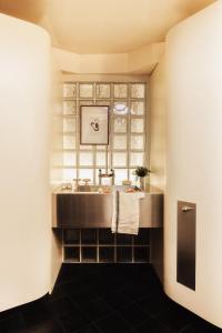 a bathroom with a sink and a window at Pied A Terre - Tuileries in Paris