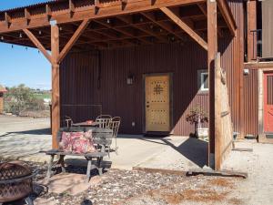 a patio with a table and chairs in front of a building at Z Ranch in Templeton