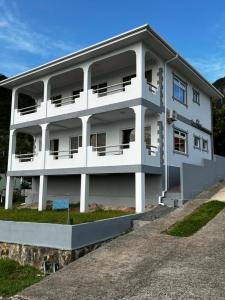 a white building with a lot of windows at Western Ocean Breeze Self Catering in Victoria