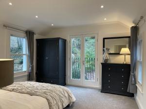 a bedroom with a bed and a dresser and a mirror at Castle View House in Lincolnshire