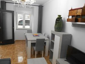 a dining room with a table and a television at A CARAMIÑA in Camariñas