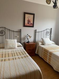 A bed or beds in a room at Alojamientos A Pedra