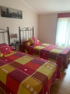 A bed or beds in a room at Alojamientos A Pedra