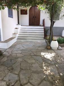 a building with a door and a stone walkway at Summer Den Plus in Ierissos