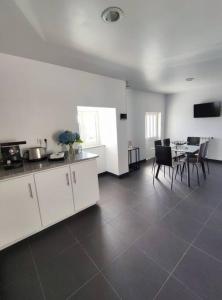 a kitchen and dining room with a table and chairs at Casa da Mata in Paredes de Coura