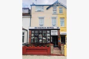 a building with a sign that reads doughnut inspections at Dunromin Hotel in Blackpool