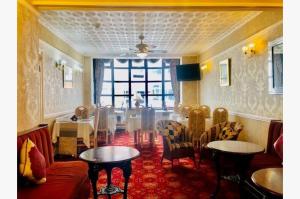 a dining room with a table and chairs and a room with a table and chairs at Dunromin Hotel in Blackpool