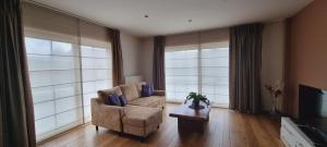 a living room with a chair and a television at SusBerg-1 & 2 in Neerpelt