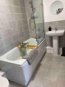 a bathroom with a toilet and a sink and a bath tub at Luxury 2 Bedroom waterfront apartment with balcony in Newport +28 photos