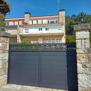 a black garage door in front of a house at Chalet Lanzada in Sanxenxo