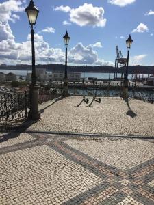 a group of street lights on a brick walkway at Cozy Estrela Apartment in Lisbon