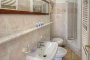 a bathroom with a sink and a toilet at Club Nautico Savona in Savona