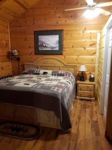 a bedroom with a bed in a wooden cabin at Beary Cuddly in Gatlinburg