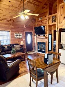 a living room with a table and a fireplace at Beary Cuddly in Gatlinburg