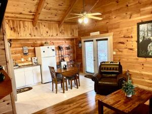 a living room with a dining room table and a kitchen at Beary Cuddly Hottub 10 Mins Downtown Gatlinburg National Park in Gatlinburg