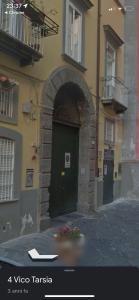 a building with an archway in front of a building at Tarsia Suite in Naples