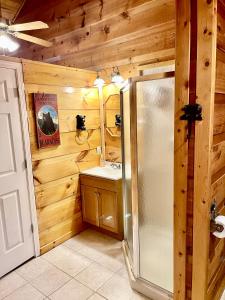 a bathroom with a refrigerator and a sink at Beary Cuddly Hottub 10 Mins Downtown Gatlinburg National Park in Gatlinburg +6 photos