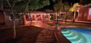 a backyard with a swimming pool at night at Relais Esmeralda in Lalla Takerkoust