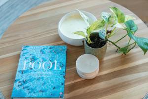 a book and a plant sitting on a table at Houston Beachfront Apartments in Gold Coast