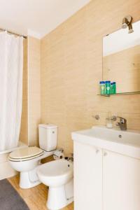 y baño con aseo blanco y lavamanos. en Appartamento Mochiri - San Isidro, en San Isidro