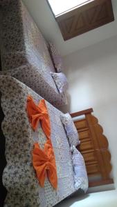 a bedroom with two bunk beds with orange sheets at Casa para Temporada as Marges do Rio Sao Francisco - PIRANHAS-ALAGOAS in Canindé de São Francisco