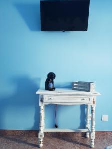 a white console table with a television on top at Hostal Pabellón in O Grove