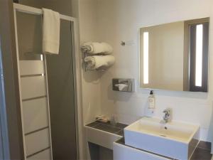 a bathroom with a sink, toilet and shower at Best Western Central Hotel in Tours