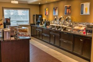 a kitchen with a buffet line with food at Best Western Plus Peace River Hotel & Suites in Peace River