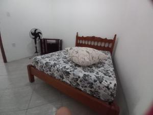 a bed with a pillow on it in a room at Camping e Hostel Praia do Saco in Estância