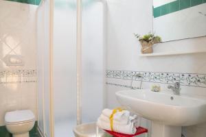 uma casa de banho com um lavatório, um WC e um chuveiro em ONDA BLU-Appartamenti em Torre dell'Orso