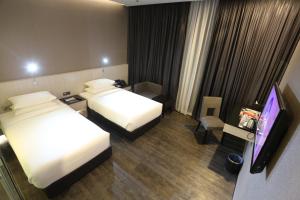 Ένα ή περισσότερα κρεβάτια σε δωμάτιο στο e.City Hotel@OneCity