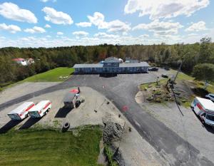 an aerial view of a building with vehicles parked in a parking lot at Norvic Motel in Coniston
