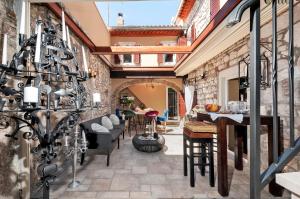 an outdoor patio with a stone wall and a table and chairs at Luxury Villa Orh Rovinj in Rovinj