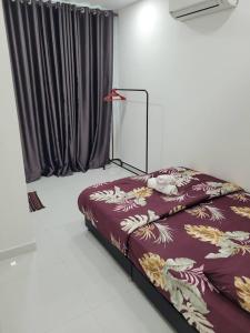 a bedroom with a bed and a lamp in it at Teduhan Abqory in Kuala Terengganu