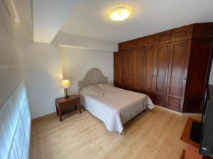 a bedroom with a bed and a table with a lamp at Eucaliptos 1102 in Lima +49 photos