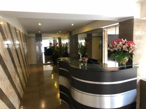 a man sitting in the lobby of a hotel at Eucaliptos 1102 in Lima
