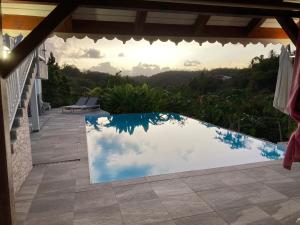 a swimming pool with a view of the sky at Maison Jean in Le Gosier