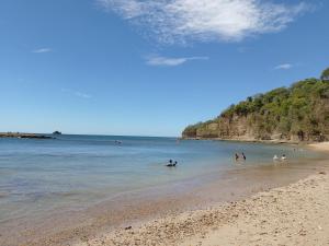 a group of people in the water at the beach at Nasu Lodge in La Cruz +25 photos