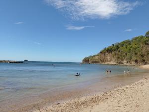 a group of people in the water at the beach at Nasu Lodge in La Cruz