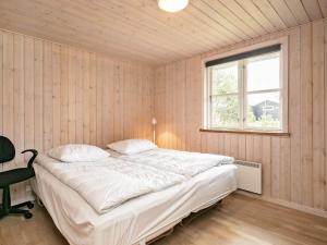 um quarto com uma cama e uma janela em Holiday home Hals CX em Hals