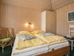 een slaapkamer met 2 bedden en een stoel bij Holiday home Hals CXI in Hals